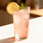 Pink Himalayan salt fasting drink with lemon and mint garnish