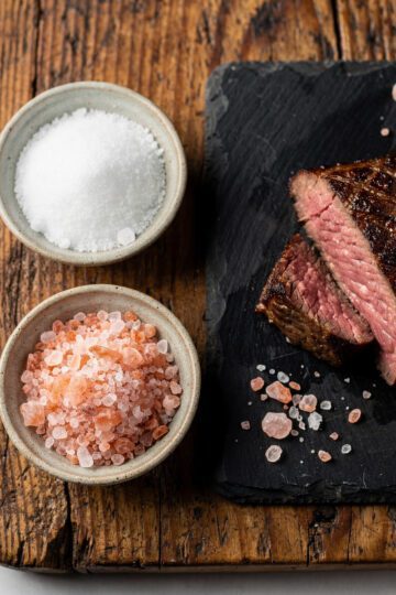 Kosher and Himalayan salt season a perfectly seared medium-rare steak.