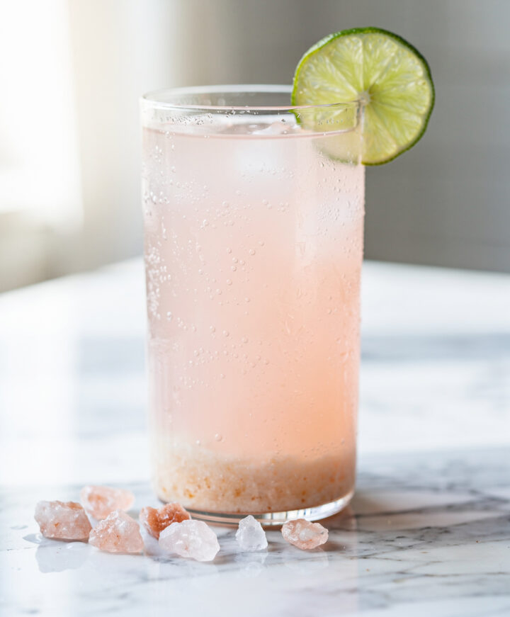 Refreshing pink coconut water electrolyte drink with lime and Himalayan salt.