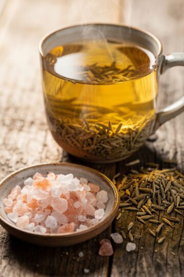 Golden Himalayan pink salt fennel tea for natural bloat relief in a mug