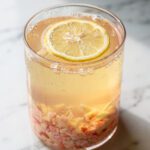 Refreshing ginger pink Himalayan salt hydration drink in clear glass jar