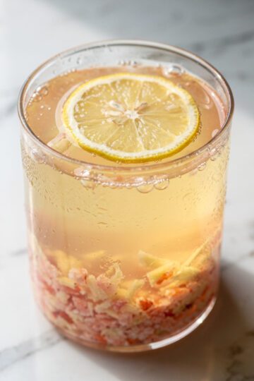 Refreshing ginger pink Himalayan salt hydration drink in clear glass jar