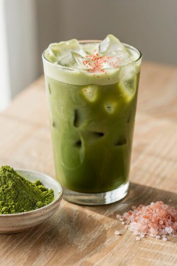 Iced matcha with pink salt for balanced flavor in a creamy chilled glass