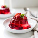 Ruby cherry gelatin with mint leaves and glossy texture