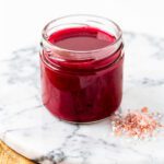 Glossy berry-red jello with pink salt in bright NYC kitchen