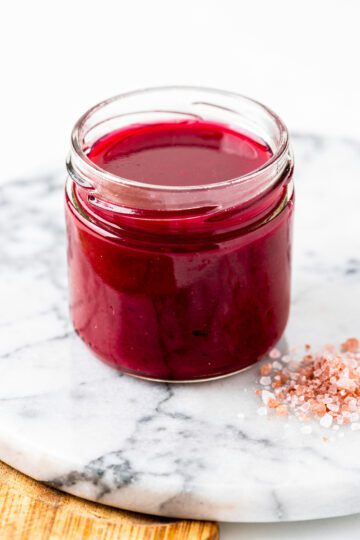 Glossy berry-red jello with pink salt in bright NYC kitchen