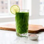Creamy green smoothie with spinach in bright NYC kitchen