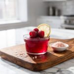 Ruby red hibiscus gelatin dessert with fresh raspberries