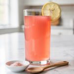 Warm pink gelatin drink on white marble countertop