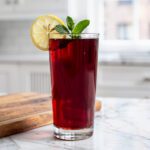 Tart cherry nightcap with lemon wheel and mint sprig