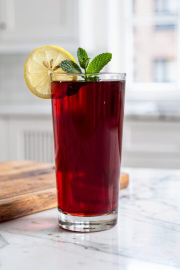 Tart cherry nightcap with lemon wheel and mint sprig