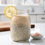 Two glass jars of chia gelatin on marble countertop.