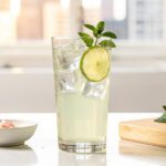 Lemon balm sparkling mocktail in bright modern kitchen