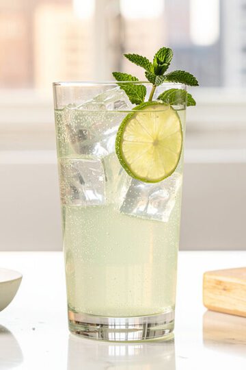 Lemon balm sparkling mocktail in bright modern kitchen