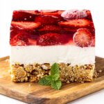 Strawberry pretzel salad layers in clear glass pan
