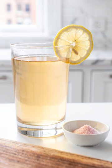 Warm gelatin water with pink salt on wood cutting board