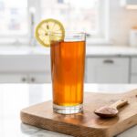 Warm morning tonic with lemon and honey on marble countertop